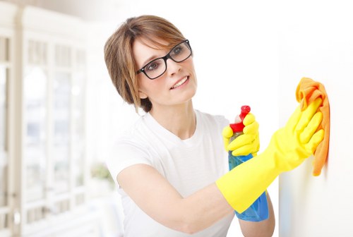 Technician applying carpet cleaning solution with care during training-based work